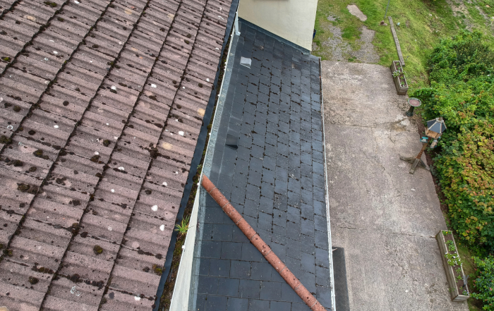Aerial view of hail damage on a residential roof showing impact marks across shingles